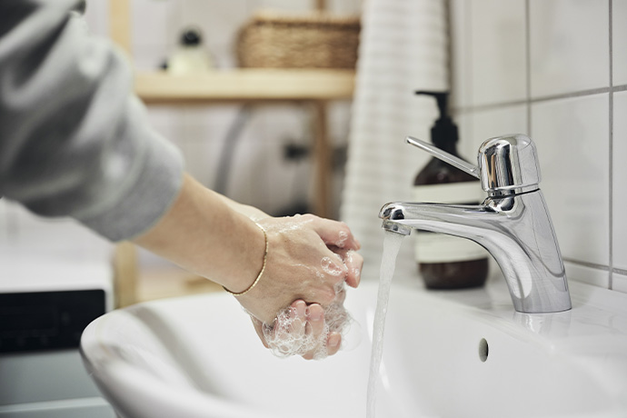  A person washing their hands in a sink